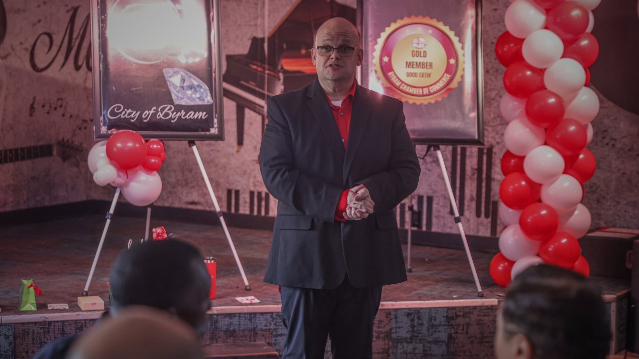 Event photography of a speaker on stage by King Williams Photography, Mississippi